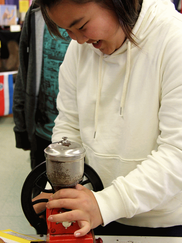 Student grinding coffee